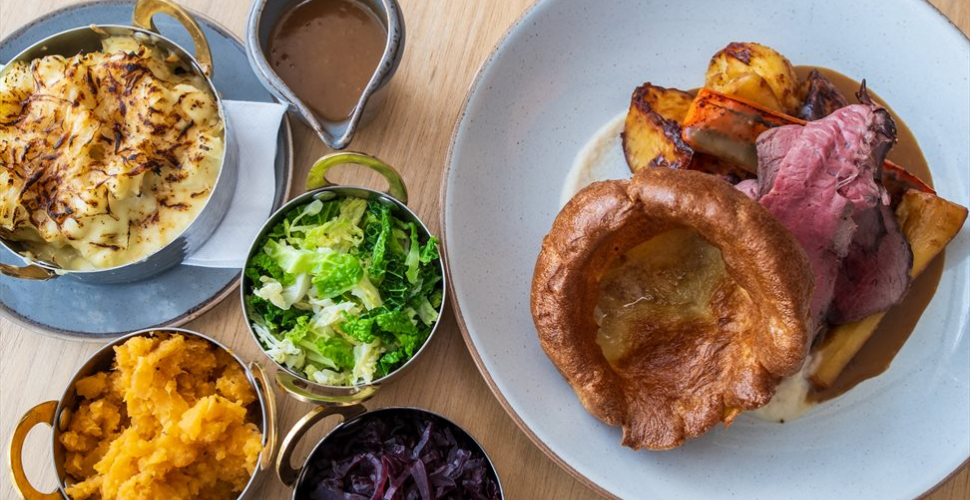 A Sunday Roast at Jolly Jacks Waterfront Bar and Bistro Plymouth 
Left to right: Cauliflower Cheese, swede, cabbage, red cabbage, a jug of gravy plus roast beef and Yorkshire pudding.